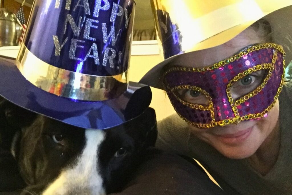 New Year celebration with rescue dog Spice, symbolizing letting go of the old and embracing consistent growth.