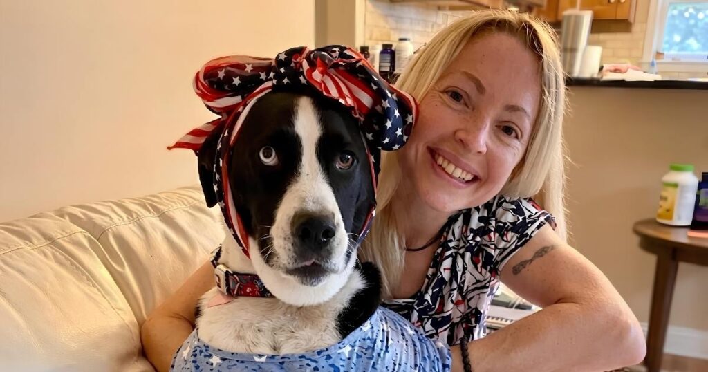Julie and Spice the rescue dog celebrating the 4th of July in patriotic red, white, and blue outfits, joyful Independence Day moment.